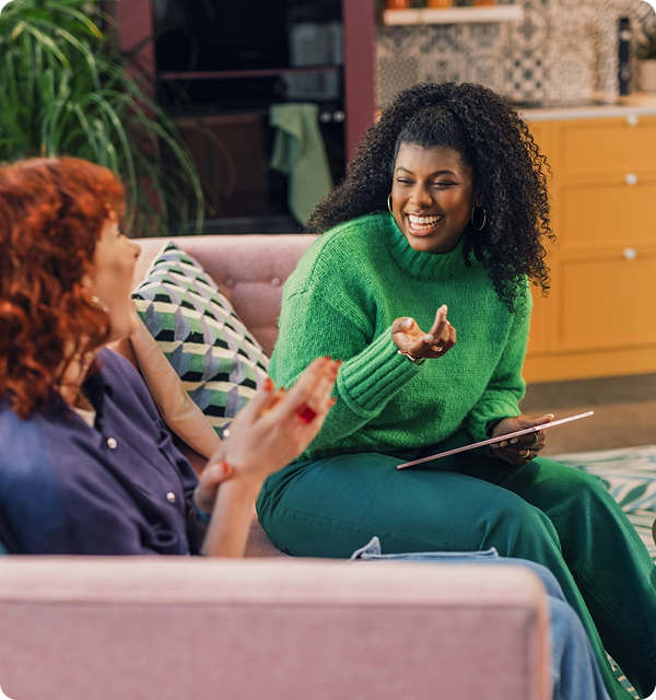 Two people talking on a couch